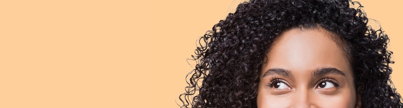 Cropped image of the top of a woman's face, eyes looking to the right.