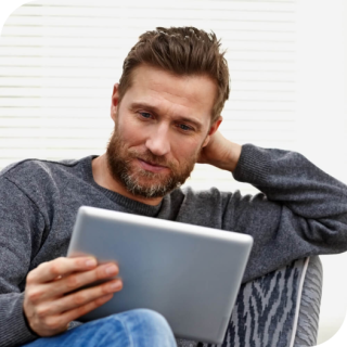 man sits and reads on a tablet